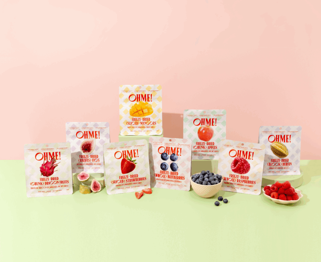 A lineup of OHME!'s bestsellers (Apples, Mangos, Strawberries and Raspberries) on a light green surface in front of a pale pink background.